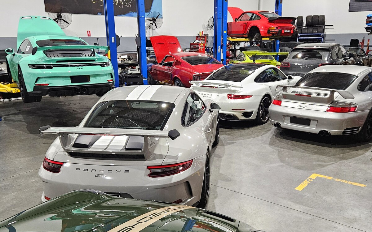 Multiple Porsche and performance cars being serviced at our fully equipped modern workshop at Ormeau